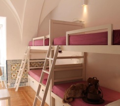 Кровать в общем номере с красивым видом из окна в Lost Inn Lisbon Hostel